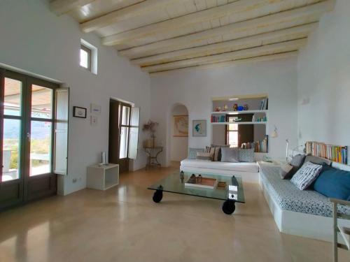 a living room with a couch and a coffee table at Amorgos Villa Handras / Main villa in Amorgos