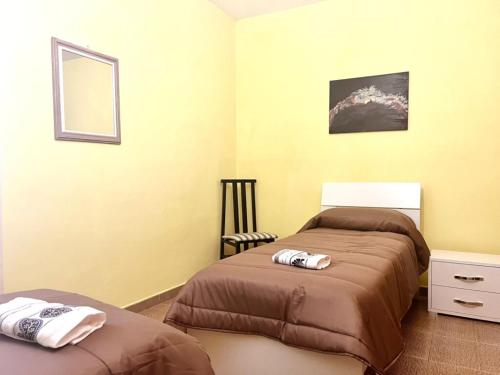 a bedroom with two beds and a mirror at Atinense Rooms in Pozzilli