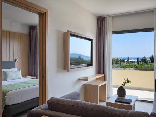 a hotel room with a bed and a window at Atlantica Mikri Poli Rhodes in Kolimbia