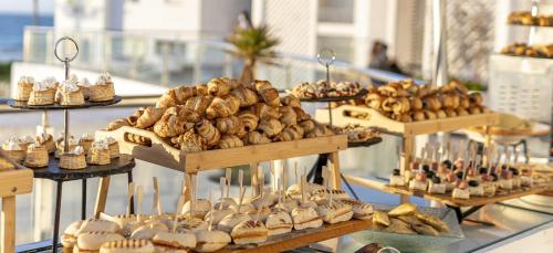 a display of different types of pastries and bread at Grand Mogador Sea View & Spa in Tangier