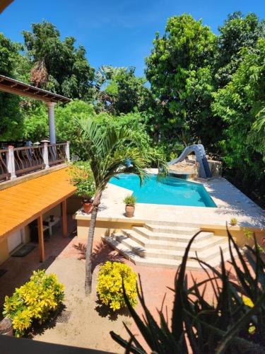 a backyard with a swimming pool and a wooden deck at Caribbean Shores Belize in Hopkins
