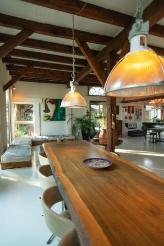 a large room with a wooden table and chairs at Farmhouse bohemian style close to Amsterdam in Waverveen