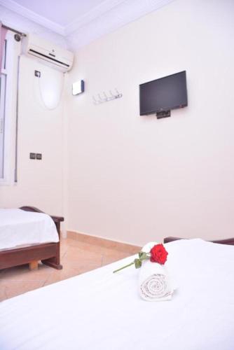 Ein Bett oder Betten in einem Zimmer der Unterkunft Hôtel Elfekri