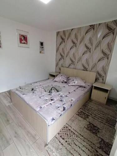 a white bed in a room with a wall at lclc in Dubova