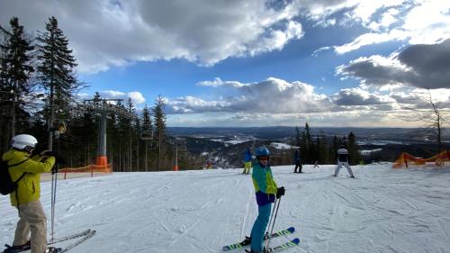 a group of people on skis on a ski slope at Apartmán Bára in Cerny Dul