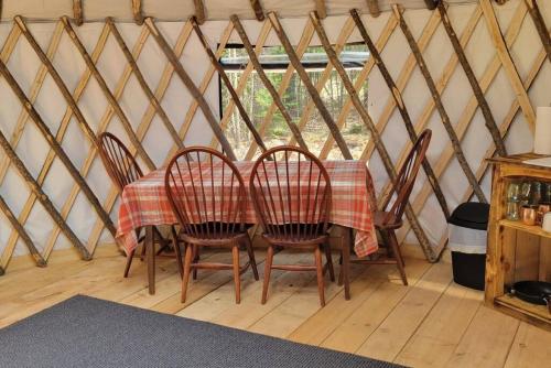 a table in a yurt with a table and chairs at Ava Jade Yurt in Brownfield