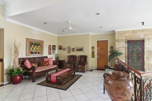 a living room with a couch and a fireplace at Puri Sawo Manila Residence in Jakarta