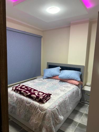 1 dormitorio con 1 cama con 2 toallas en كمبوند اللوتس en Hurghada