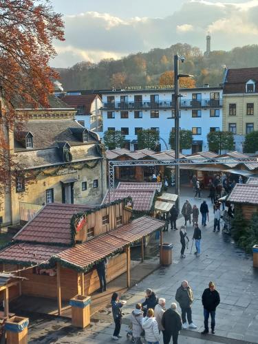 a group of people walking around a town with buildings at Top! Appartement Valkenburg in Valkenburg