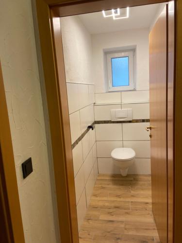 a small bathroom with a toilet and a window at Haus Eder Steiner in Saalbach Hinterglemm