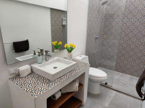 a bathroom with a sink and a toilet and a shower at Casa Monarcas - Sophia (with AC) in Guadalajara