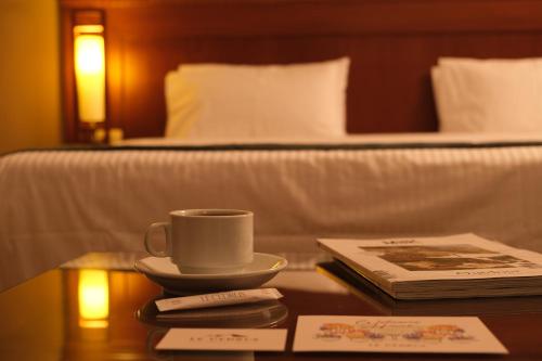 a cup of coffee on a table in a hotel room at Le Cedrus Hotel in Al Arz