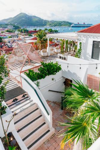 a staircase on a building with a view of a city at The Pink Palm Hotel - Adults Only in Charlotte Amalie