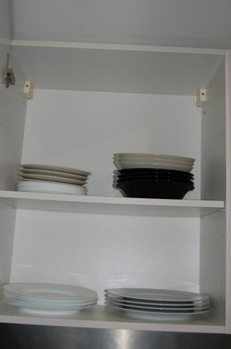 阿克斯萊泰爾姆的住宿－Studio La LAUZE，白色的架子,上面有盘子和盘子