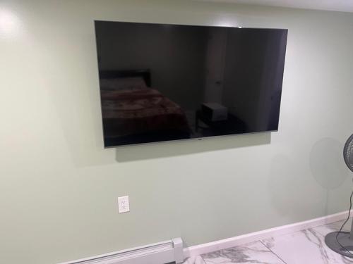 a mirror on the wall of a bedroom at Single Room in Elmont