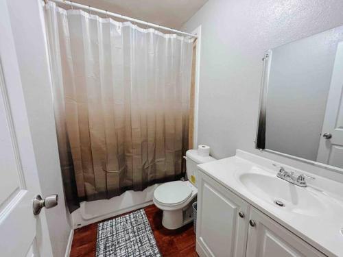 a bathroom with a toilet and a shower and a sink at Workforce Ready 2 bedroom Home in Corpus Christi