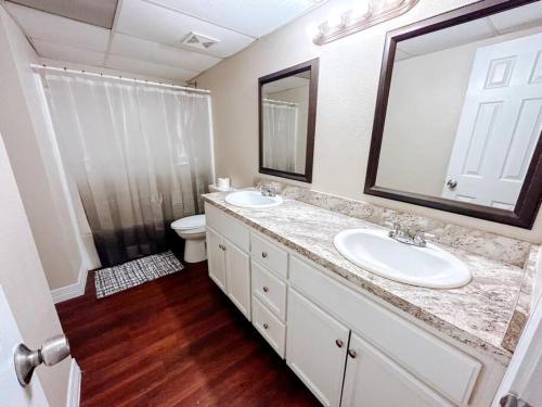 a bathroom with a sink and a toilet and a mirror at Workforce Ready 2 bedroom in Corpus Christi