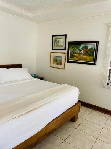 a bedroom with a bed and three pictures on the wall at Casa Mano de Tigre in Potrerillos