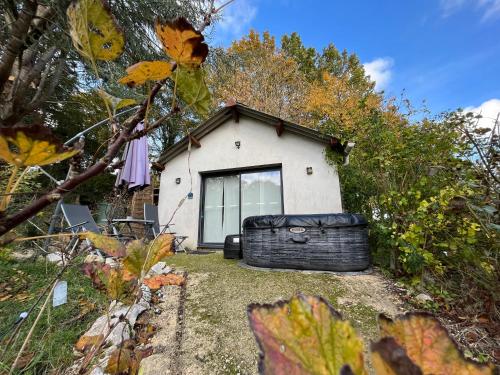 a house with a large tire in front of it at Cottage-Gite & Jacuzzi - Chez Flo & Marc in Chouzy-sur-Cisse