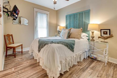 a bedroom with a bed and a chair and a window at Hot Tub Golf Cart Near beach Coastal Retreat in Bolivar Peninsula