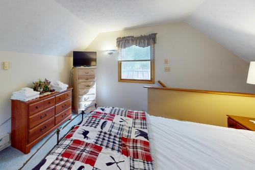 a bedroom with a bed and a dresser at Life's A Bear in McHenry