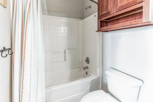 a bathroom with a tub and a toilet and a shower at Steps to beach Golf Cart About Time Beach Retreat in Bolivar Peninsula