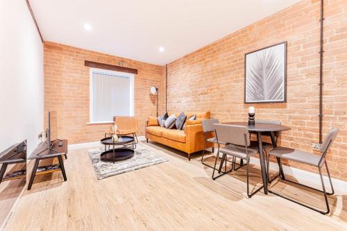 a living room with a brick wall at Spacious 2 Bed Apartment in Burton-on-Trent in Burton upon Trent