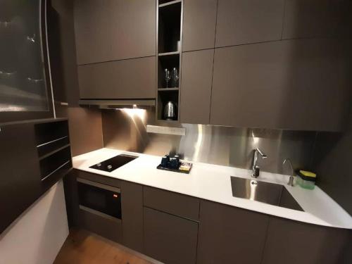 a kitchen with a sink and a counter top at Ceylonz Suites By ANA MALAYSIA in Kuala Lumpur