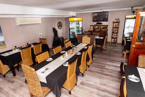 a restaurant dining room with tables and chairs at Kleinplasie Guesthouse in Springbok