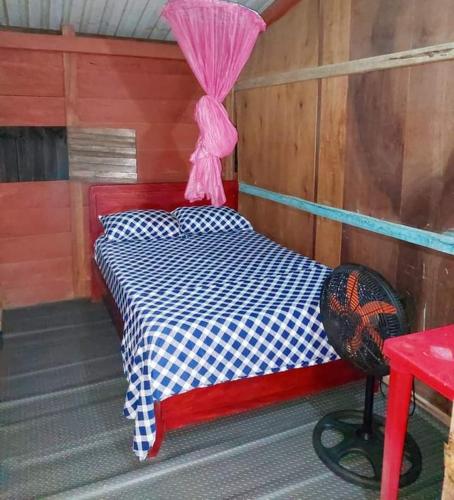 מיטה או מיטות בחדר ב-Palapa Abraham