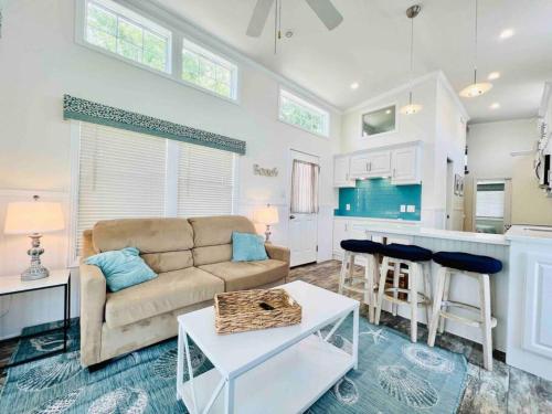 a living room with a couch and a kitchen at Vacation Cottage North Myrtle Beach 65 in Myrtle Beach