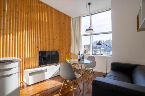 a living room with a couch and a table at Boavista 1774 by LovelyStay in Porto