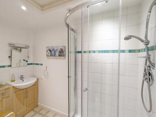 a bathroom with a shower and a sink at Fishermans Cottage, Felpham in Felpham