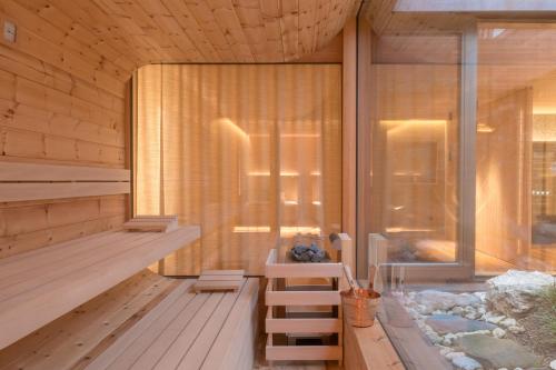 a sauna with a bench next to a window at Milla Apartments in Bressanone