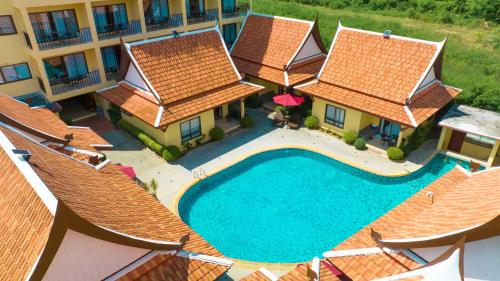 an aerial view of a resort with a swimming pool at Kana Hotel Phuket普吉岛卡娜酒店 in Rawai Beach