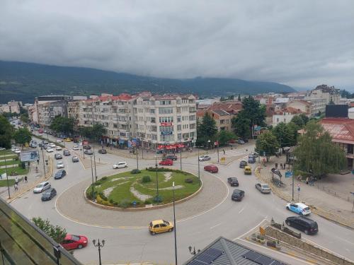 a city with a street with cars and buildings at Petreski Apartments 1 in Ohrid