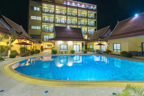 a swimming pool in front of a hotel at night at Kana Hotel Phuket普吉岛卡娜酒店 in Rawai Beach