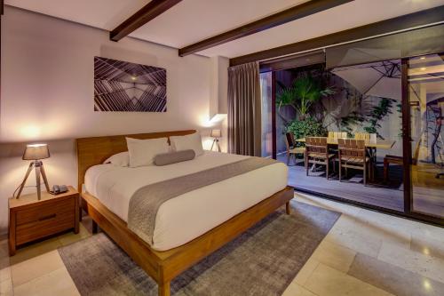 a bedroom with a bed and a dining room at MX Grand Suites in Mexico City