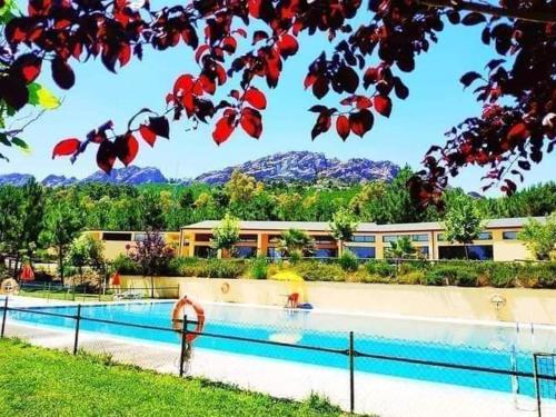 a resort swimming pool with mountains in the background at Camping AGUAS CLARAS in La Acena de la Borrega