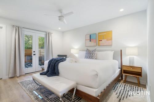 a white bedroom with a white bed and a chair at Close to Barton Springs and Zilker w King BR and Patio in Austin