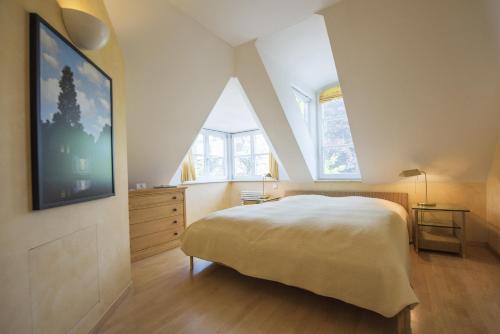 a bedroom with a bed and a large window at ArtVilla am See - offen März bis Ende Oktober in Radolfzell am Bodensee