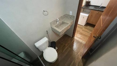 a small bathroom with a toilet and a sink at Pousada Central Praias II in São Pedro da Aldeia