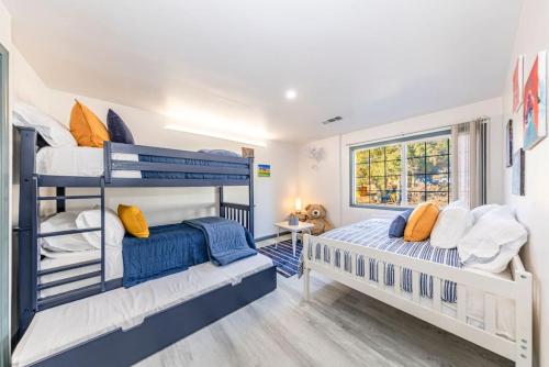 two bunk beds in a room with a window at Starry Night Cabin at Sky Ranch in Oakhurst