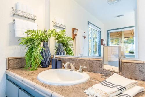 a bathroom with a sink and a mirror at Starry Night Cabin at Sky Ranch in Oakhurst