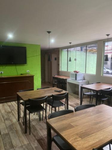 a restaurant with tables and chairs and a flat screen tv at Hotel Real Centro in Sao Paulo