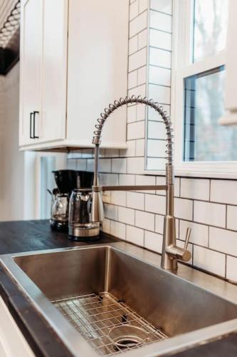 a stainless steel sink in a kitchen at Luxury Cliffside Hammock House in Wellington