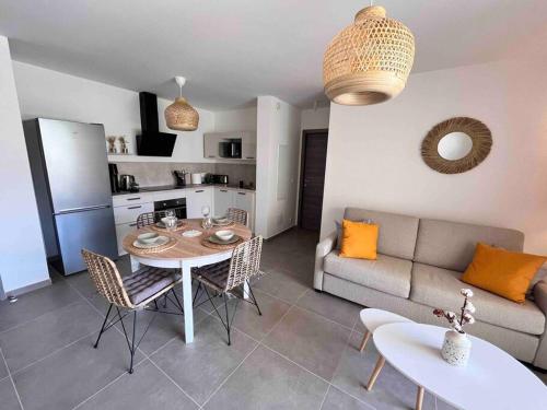 un salon avec une table et un canapé dans l'établissement Un havre de paix entre mer et montagne à Sant'Ambroggio, à Lumio