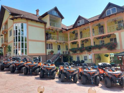 a row of atvs parked in front of a building at PENSIUNEA MIHAELA-Transalpina in Novaci