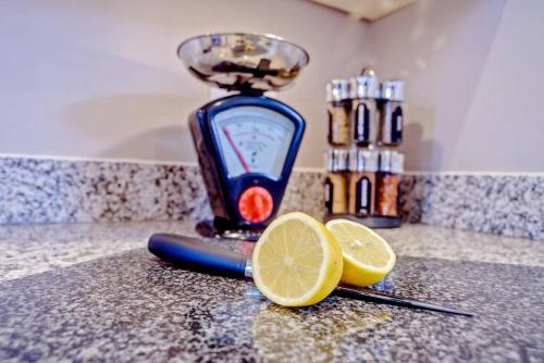 a juicer with a slice of lemon on a counter at Pennyroyal Lodge HM31 Lakeside Spa Property in Somerford Keynes