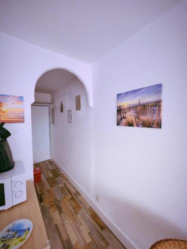 una sala de estar con 2 cuadros en la pared en Studio vacances proche de la mer, en Le Grau-du-Roi